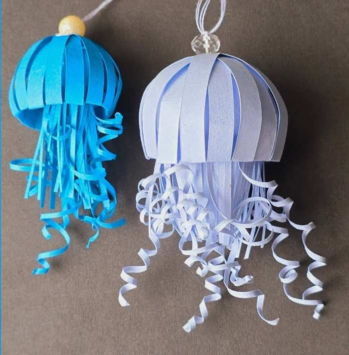 Paper jellyfish craft made with colorful paper strips and dome top